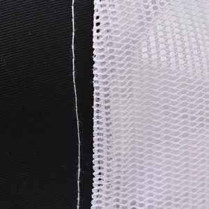 Macro detail of high-quality stitching between black fabric and white honeycomb mesh material