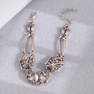 Detail view of retro rose gold gothic skull bracelet with articulated hand joints and lobster clasp