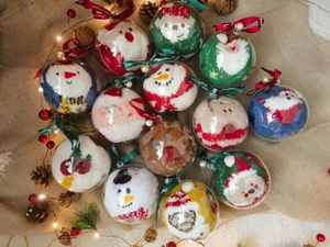 Festive Christmas fuzzy socks in clear bauble gift packaging with holiday characters
