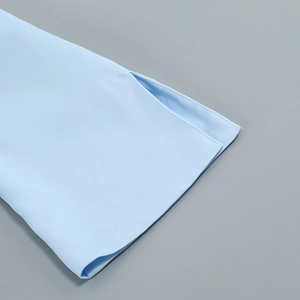 Detail of light blue dress showing fine stitching and side slit hem design