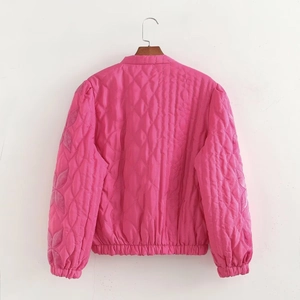 Rear view of pink quilted jacket with leaf-pattern stitching and elastic cuffs