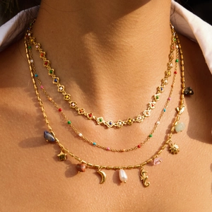 Layered gold flower necklaces with colorful beads, moon and sea horse charms for women