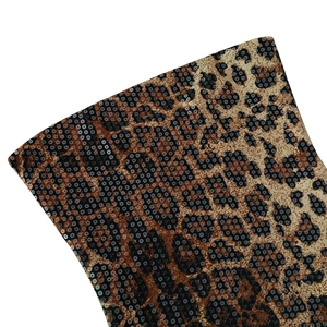 Close-up of leopard print fabric with shimmering sequins and detailed textile texture