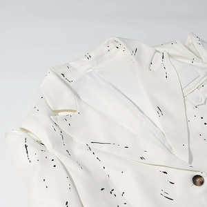 Artistic V-neck blazer with black graffiti splatter pattern and shoulder cutout detail