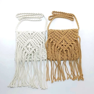 Detailed view of handmade macramé shoulder bags with woven geometric patterns and long fringes
