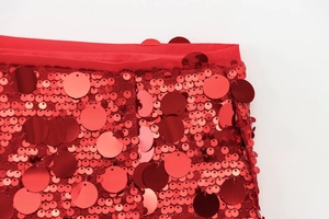 Detailed macro view of shiny red sequins and fine mesh fabric on a sequined A-line skirt