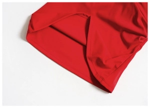 Close-up of high-quality flatlock stitching on red brushed fabric yoga wear hem