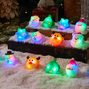 LED Christmas rings set with Santa and snowman glowing icons on vintage book props