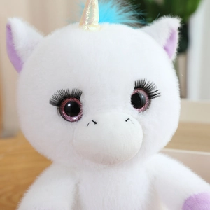 Detailed close-up of a plush unicorn with sparkly horn and long decorative eyelashes