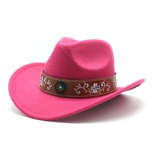 Detail of rose red felt cowboy hat featuring embroidered brown leather band and turquoise stud