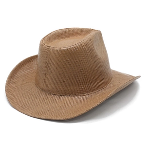 Detailed texture of brown woven western cowboy hat with wide brim and creased crown