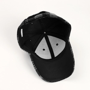 Detail of checkered baseball cap interior showing black lining and care label