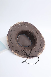 Macro detail of dark brown cowboy hat showing frayed edges and adjustable chin strap