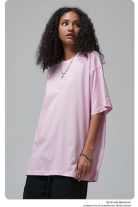 Detail of pink cotton oversized t-shirt featuring dropped shoulder and round neckline