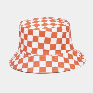 Detailed view of the orange and white checkerboard pattern on the canvas sun hat