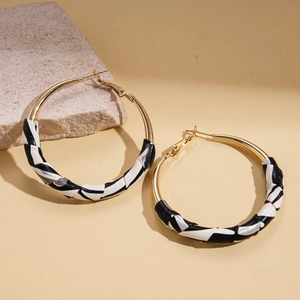 Leopard print leather wrapped gold hoop earrings with black and white textured pattern