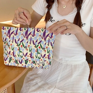 Canvas tulip makeup bag with floral print and zipper closure for travel storage