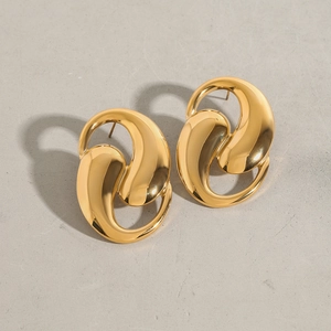 Macro detail of high-quality gold titanium steel earrings with abstract irregular design