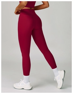 Detail view of high-waist seamless compression yoga leggings in deep burgundy wine red