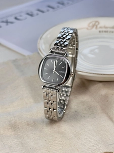 Minimalist square black dial watch with silver stainless steel strap on linen fabric