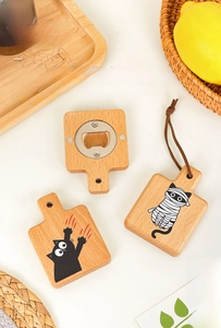 Detail of wooden cat claw bottle opener with magnetic back and hanging strap