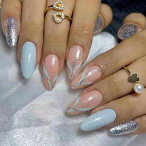 Blue and silver glitter almond press-on nails with linear patterns on silk background