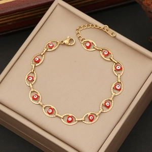 Gold stainless steel evil eye heart charm bracelet displayed in a beige jewelry box