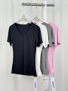 Detail view of the V-neck cotton T-shirts in four colors on hangers with brand tags