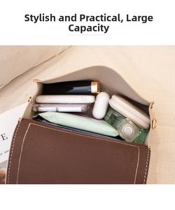 Top view of a flap crossbody bag showing spacious interior with phone and cosmetics