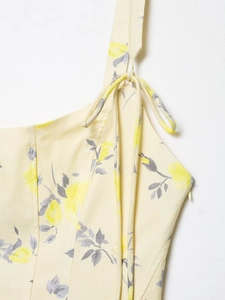 Detail of floral poplin dress with adjustable shoulder straps and yellow flower print