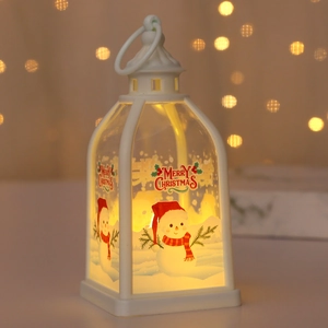 Detail of white Christmas lantern with snowman motif and warm LED light decoration