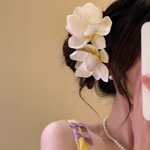 Tropical frangipani flower hair clip in cream white for elegant summer beach styling