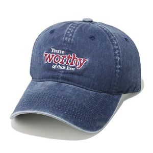 Detail of embroidered lettering on retro washed denim baseball cap with reinforced stitching