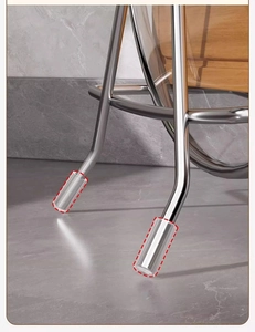 Close-up of stainless steel furniture leg protector caps installed on metal chair legs