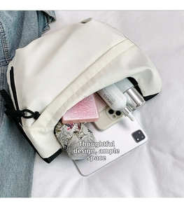 Detail showing the large interior capacity of this cream tote bag with daily essentials