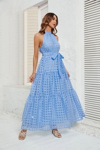 Detail of light blue halter-neck tiered maxi dress with textured checkered fabric