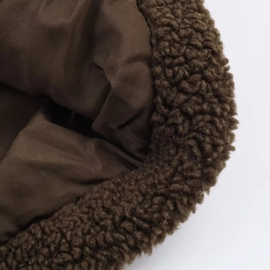 Detailed macro view of dark coffee lamb wool fabric with smooth inner lining