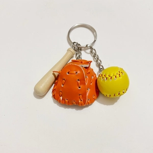 Detailed view of orange leather baseball glove and yellow ball keychain accessories