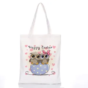 White canvas tote bag featuring cute cartoon owls and Happy Easter festive print
