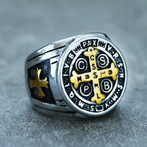 Macro shot of silver and gold Saint Benedict medal ring with detailed engraving