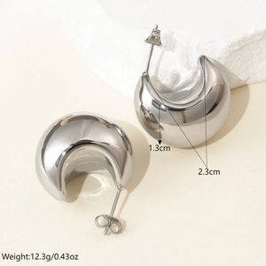 Detailed view of silver crescent hoop earrings with 2.3cm height and 1.3cm width dimensions