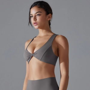 Dark gray twist-front sports bra with seamless breathable fabric for yoga and fitness