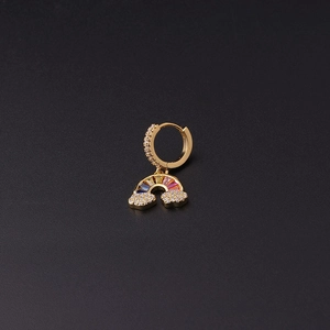 Detail of gold-plated huggie earring with zircon rainbow pendant and cloud charms