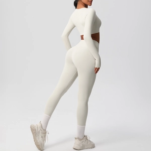 Detail view of the back of a cream yoga set featuring long sleeve top and leggings
