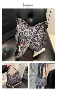 Detail view showing gray leopard print tote with wide black strap and gold hardware