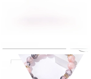 Detail of 10mm pink zebra stone and lava rock beaded bracelet with rhinestone spacers