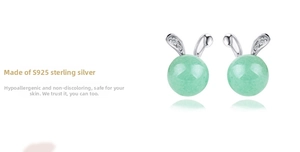 Macro detail of S925 sterling silver bunny earrings with green jade beads and zircon accents