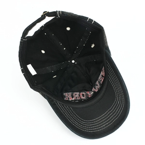 Detail view of cotton baseball cap interior featuring 100% cotton label and New York embroidery