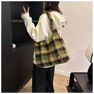 Detail of green plaid plush tote bag showing soft lamb wool texture and large capacity