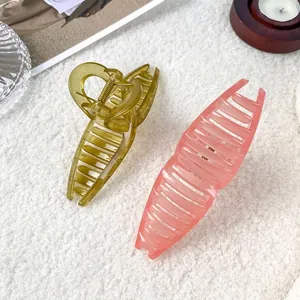 Large jelly color hair claws in amber and pink tones on a soft textured background
